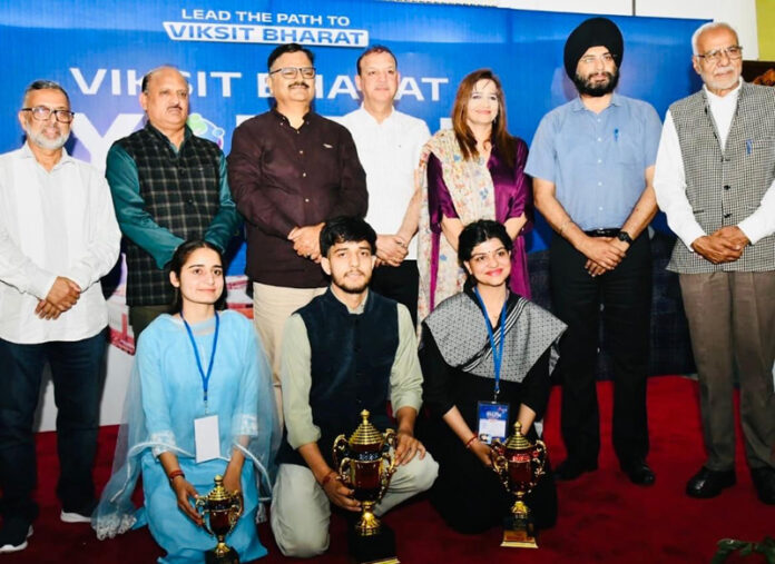 Minister Javed Rana posing for photograph with winners of J&K Viksit Bharat Youth Parliament on Wednesday.