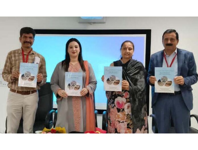 Prof Neelu Rohmetra releasing a booklet on disaster preparedness at University of Jammu on Friday.
