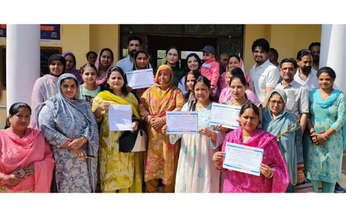 Women displaying loan letters distributed among them by MLA Nagrota, Devyani Rana on Sunday.
