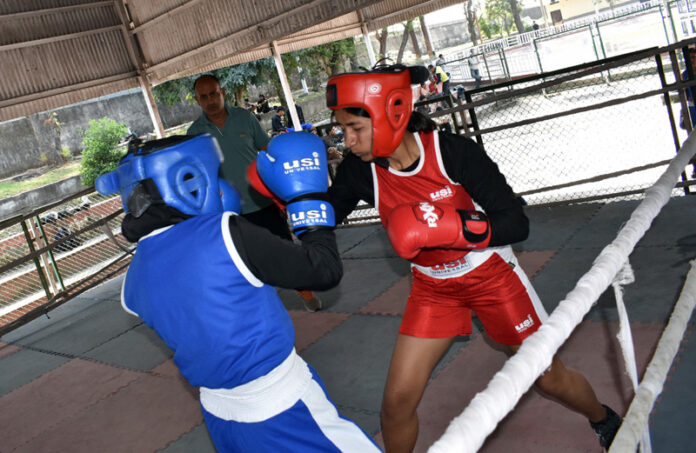 Boxers in action during Jammu District Boxing Championship match in Jammu.