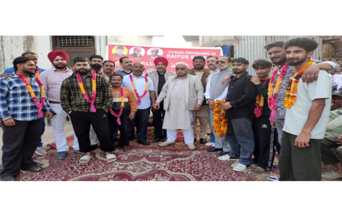 Additional general secretary and former Minister Ajay Kumar Sadhotra with new entrants at Raipur, Satwari in Jammu Cantonment.