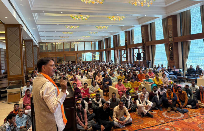 MLA Baldev Raj Sharma speaking during a function in Katra.
