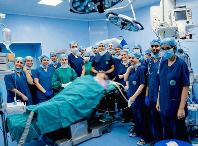 A team of doctors led by Prof (Dr) D N Sharma, Executive Director and CEO, AIIMS Jammu posing along with their patient at AIIMS Jammu.