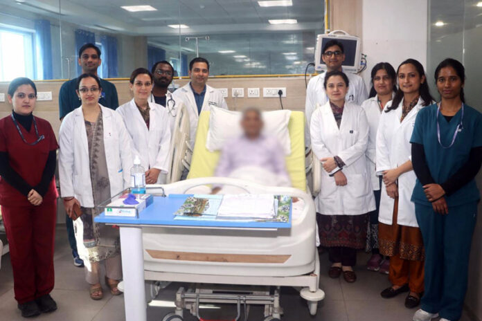 A team of doctors posing with a patient on whom it performed a highly complex surgery at AIIMS Jammu.
