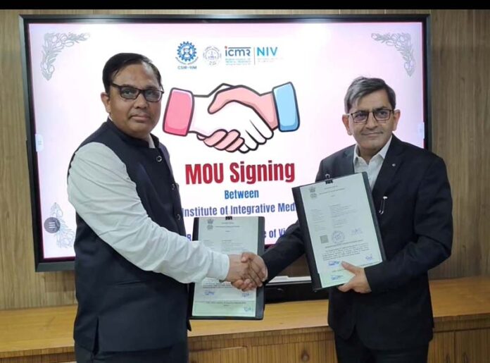 Directors of CSIR-IIIM and ICMR-NIV shaking hands after signing MoU between the two institutions.