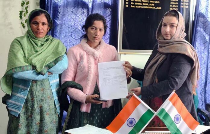 ALC Kishtwar handing over compensation to the family of Ashish Kumar who lost his life at the Rattle Hydroelectric Power Project while on duty.