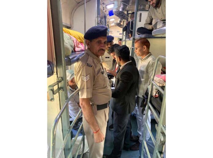 Railway staff conducting ticket checking in train.