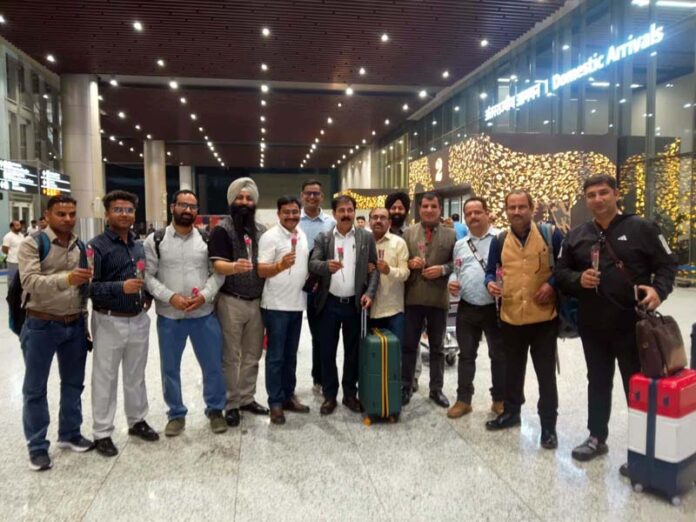 Journalists from Jammu posing for a group photograph after their arrival at Lucknow Airport.