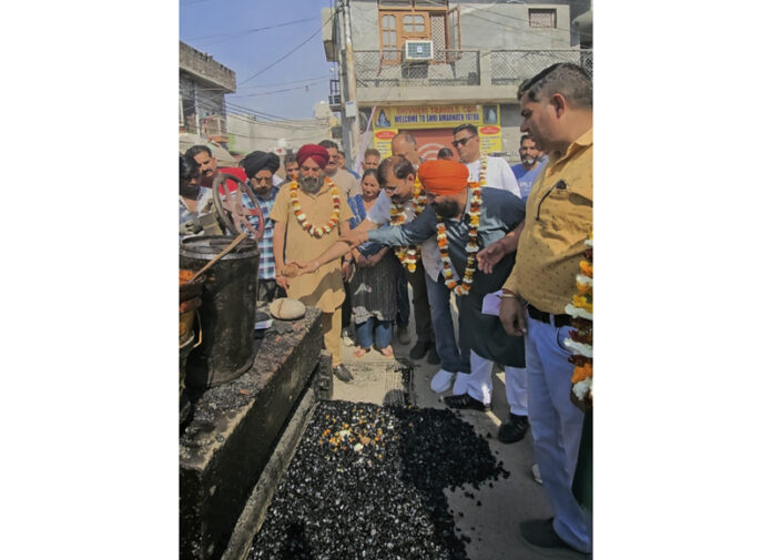MLA Jammu West, Arvind Gupta kick starting the blacktopping of Revenue Complex road at Bhagwati Nagar on Thursday.