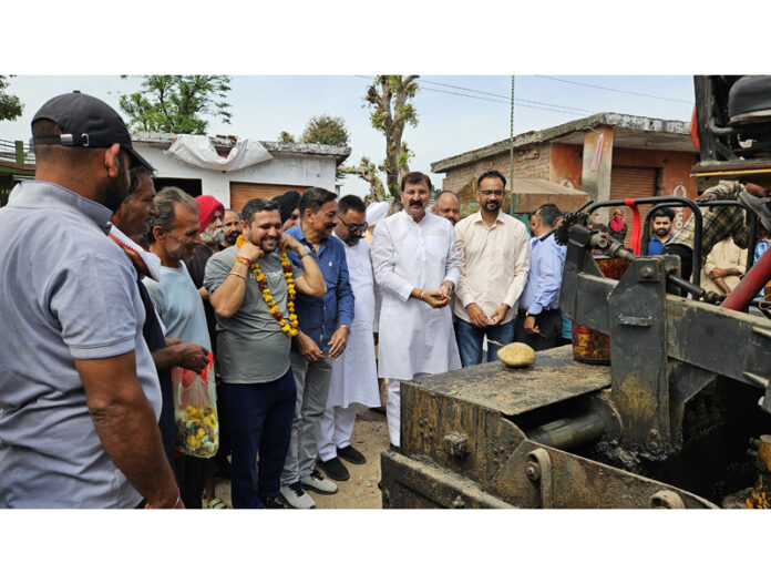 MLA Jammu West Arvind Gupta kick starting blacktopping of road in Kharian area. MLA Jammu West Arvind Gupta kick starting blacktopping of road in Kharian area.