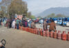 People waiting for LPG at Tawhid Chowk in Ganderbal on Saturday. -Excelsior/Firdous Ahmad
