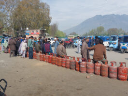 People waiting for LPG at Tawhid Chowk in Ganderbal on Saturday. -Excelsior/Firdous Ahmad