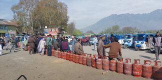 People waiting for LPG at Tawhid Chowk in Ganderbal on Saturday. -Excelsior/Firdous Ahmad