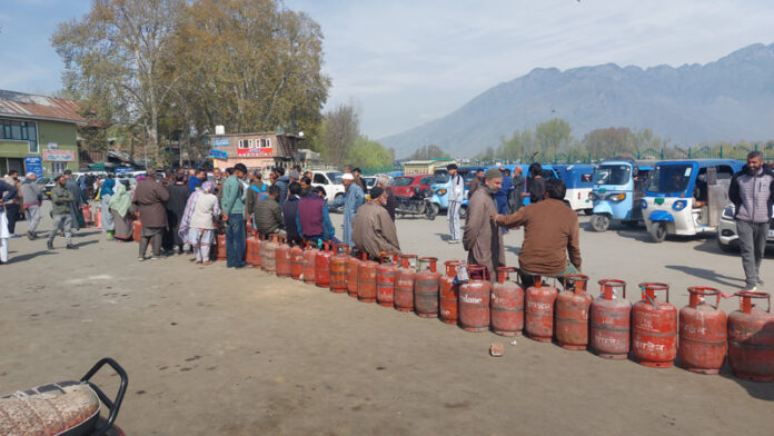 People waiting for LPG at Tawhid Chowk in Ganderbal on Saturday. -Excelsior/Firdous Ahmad