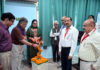 Guests lighting ceremonial lamp during inauguration of conference at JU.