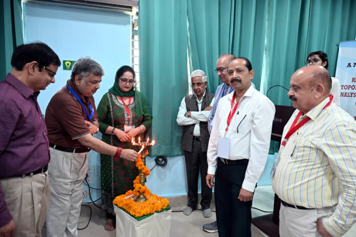 Guests lighting ceremonial lamp during inauguration of conference at JU.