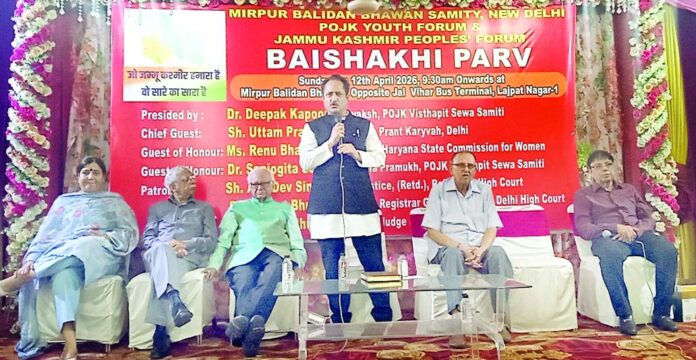 A speaker from the POJK Displaced Families interacting with community members during the celebration of Baisakhi Parv in New Delhi on Sunday.