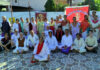 Participants posing along with management committee during a programme.
