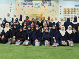 Students posing along with dignitaries during a programme.