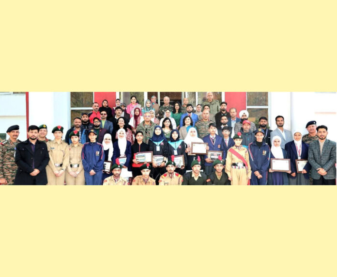 Outstanding achievers in innovation, sports and academics from Army Goodwill Schools posing with dignitaries in Srinagar.