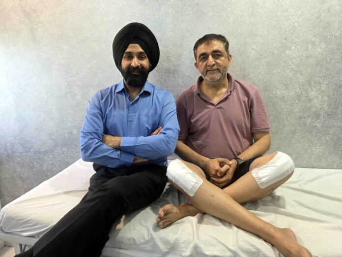 Dr Ranjit Singh posing with a patient on whom he performed 20-minute knee replacement using 3D Robolens technique.