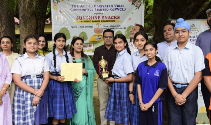 Dignitaries presenting trophy to students of Jammu Sanskriti School.