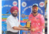 Dignitary presenting player of the match award.