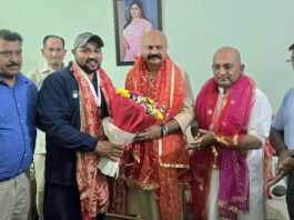 MLA Jammu East Yudhvir Sethi felicitating young handball player Anuj Langer.