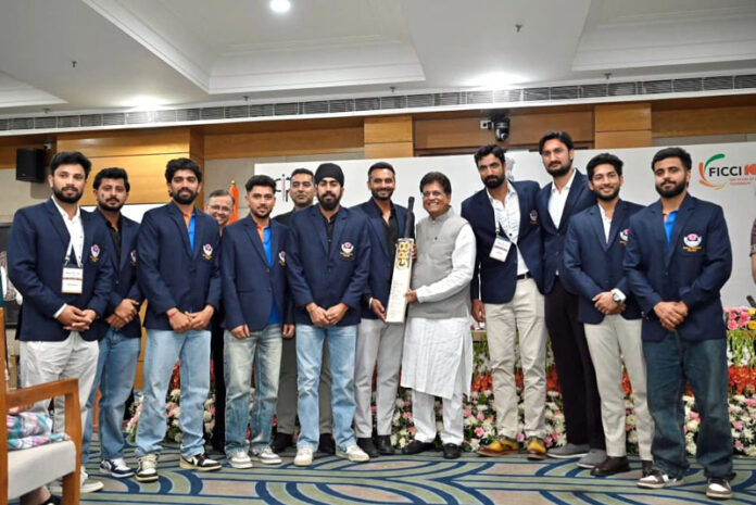 Union Minister Piyush Goyal with J&K Ranji team during a programme in New Delhi.