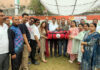 Dignitaries presenting sports kits to Boys HSS Udhampur during an event.
