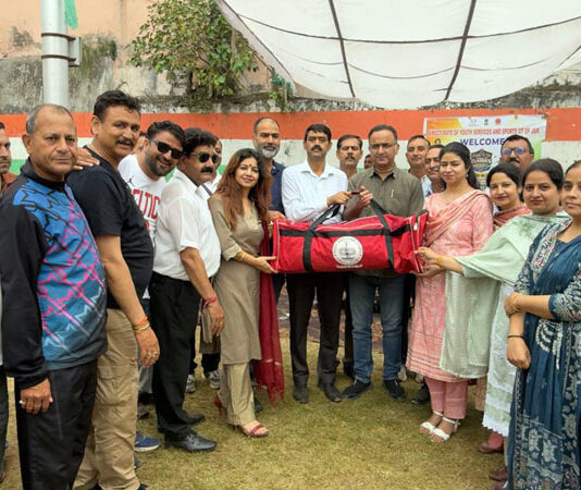 Dignitaries presenting sports kits to Boys HSS Udhampur during an event.