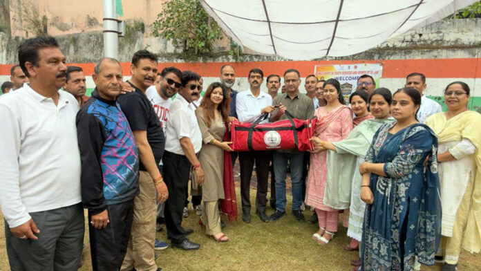 Dignitaries presenting sports kits to Boys HSS Udhampur during an event.