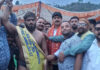 Wrestler posing along with dignitaries.