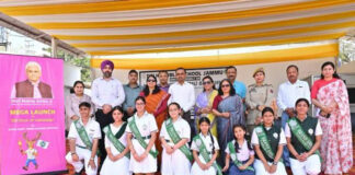 Students posing along with dignitaries during a programme.