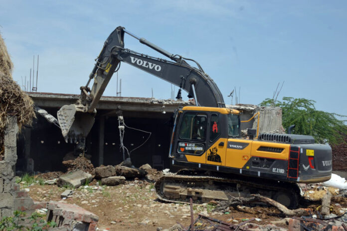 An illegal structure being demolished at Nikki Tawi area on Saturday. -Excelsior/Rakesh