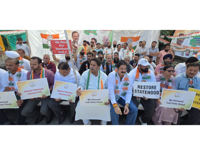 Congress leaders and workers staging protest dharna in Jammu on Sunday. -Excelsior/ Rakesh