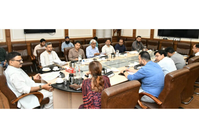 Minister Javed Rana chairing a meeting at Jammu on Monday.