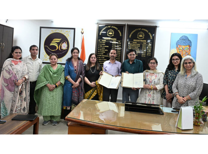 MD POSHAN J&K, Sajad Hussain Ganai and Dr Neeraj Sharma (Registrar JU) along with others during inking of MoU.