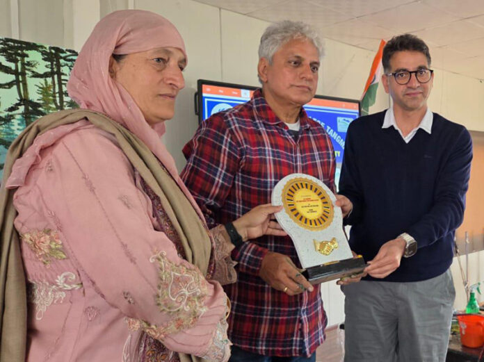 K K Gandhi receiving a memento during a function in Gulmarg.