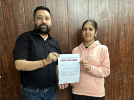Dr Karan Nayyar posing along with Tamanna Saini with sponsorship letter.