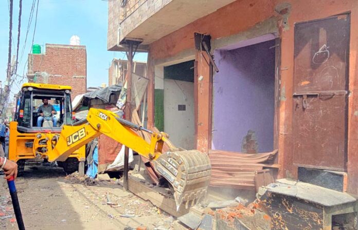 An illegal structure being demolished at Rajiv Nagar area of the Jammu district on Thursday. -Excelsior/Rakesh