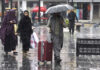 People walk with their umbrellas during rainfall in Srinagar on Friday. — Excelsior/Shakeel