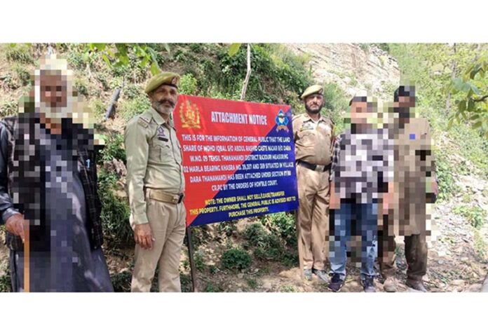 Police attaching the property of terror handler in Thannamandi.