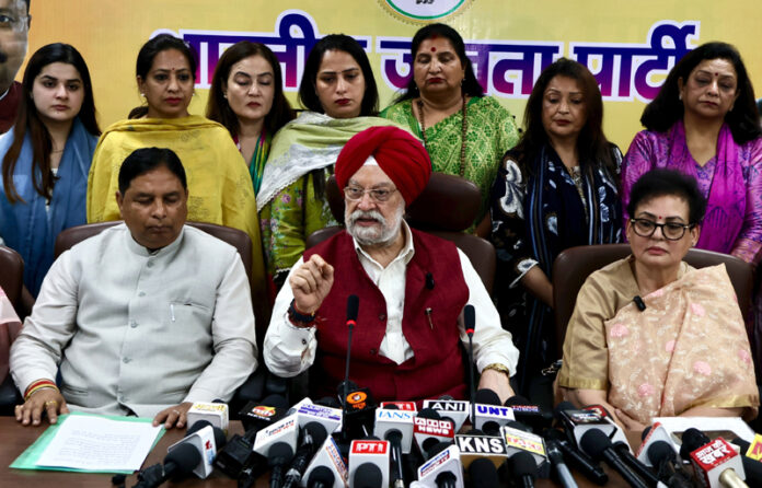Union Minister Hardeep Singh Puri along with BJP president Sat Sharma and Rajya Sabha MP Rekha Sharma addressing a press conference at Party office in Jammu on Sunday. (UNI )
