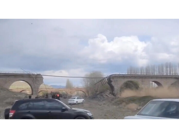 A railway bridge hit in a strike near Amin Abad, Iran on Tuesday.