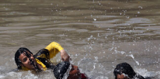 People enjoying bath in Ranbir canal on a hot summer day in Jammu. - Excelsior/Rakesh