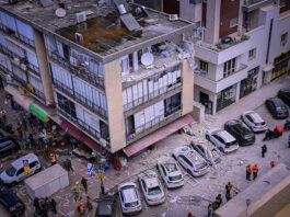 Israeli security and rescue forces at the scene where a missile fired from Iran caused damage in Ramat Gan on Monday.