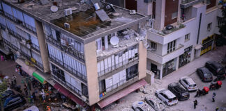 Israeli security and rescue forces at the scene where a missile fired from Iran caused damage in Ramat Gan on Monday.