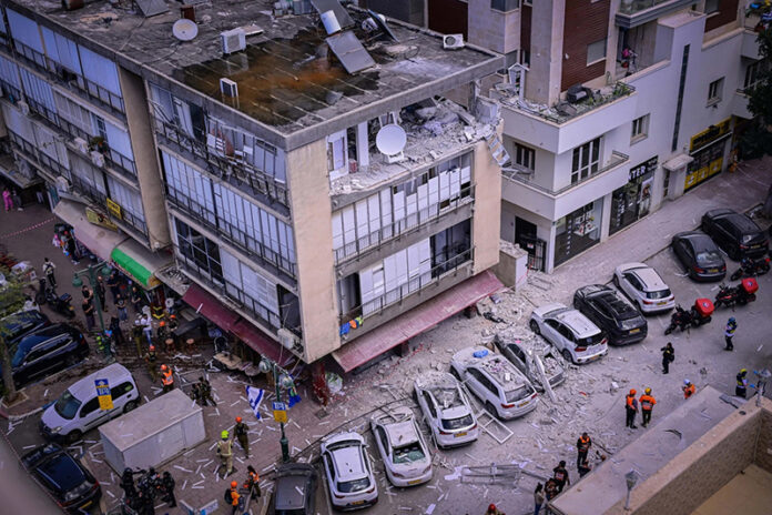 Israeli security and rescue forces at the scene where a missile fired from Iran caused damage in Ramat Gan on Monday.
