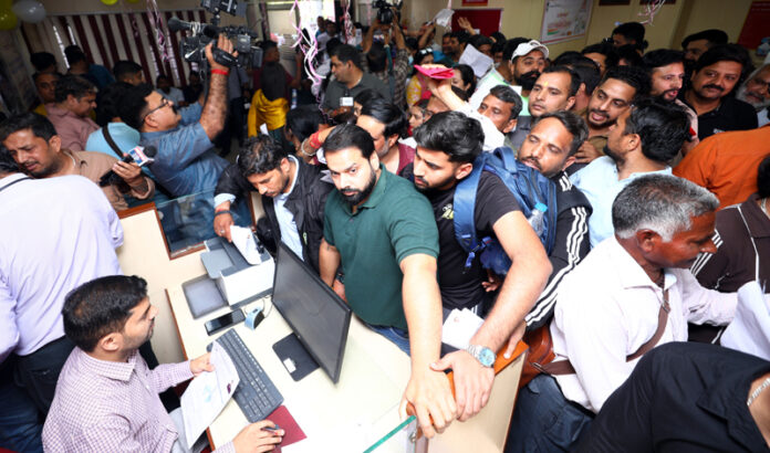 Devotees in long queues before a registration counter of PNB at Rehari Chowk. -Excelsior/Rakesh